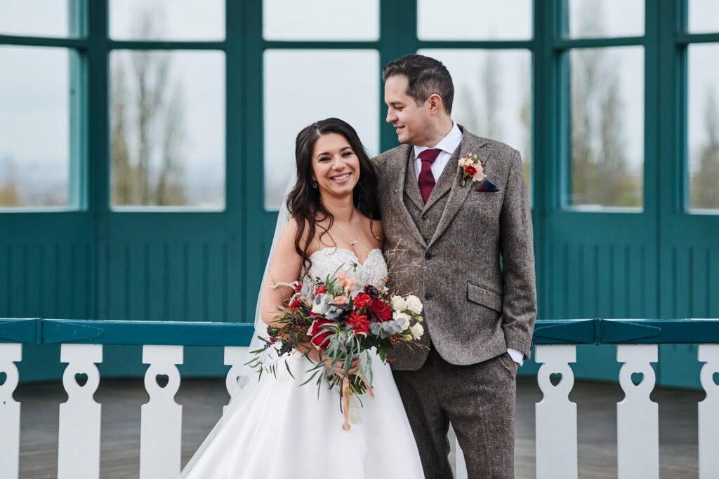 bride and groom in front of the bandstand at The Horniman museum. 