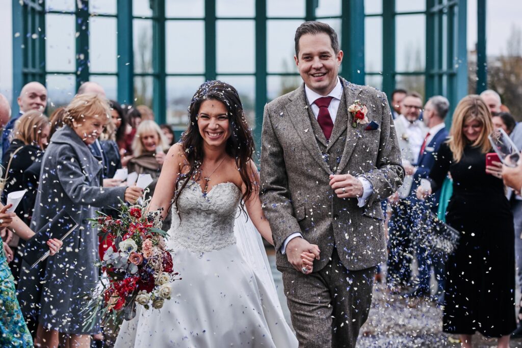 Bride and groom having confetti thrown over them during Horniman Museum wedding
