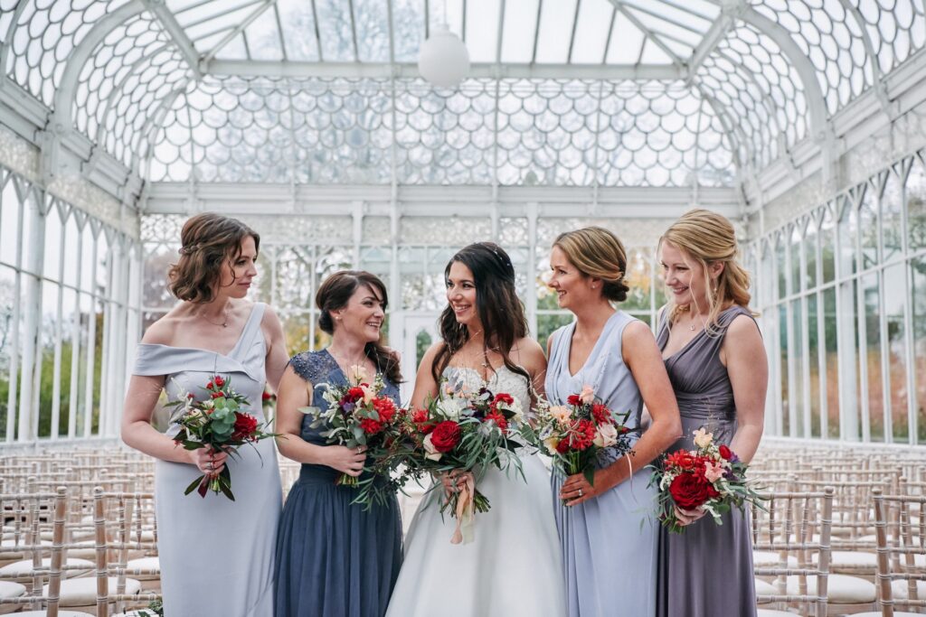 Bride smiling with her bridesmaids in the conservatory at The Horniman Museum