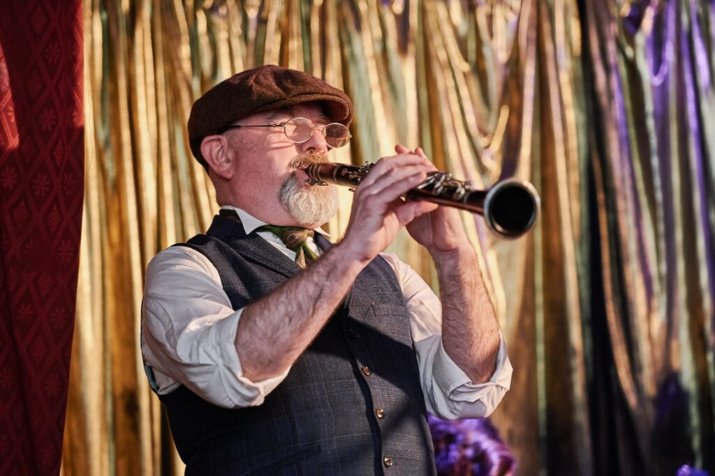 Flute player on the stage during winter wedding at Ivy House