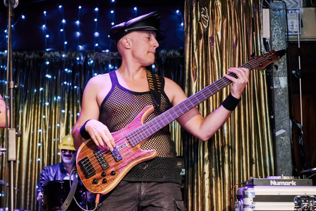 Glam rock wedding guest with guitar performing at The Ivy House pub