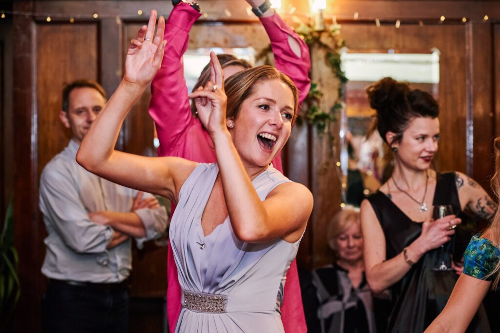 Bridesmaid having fun during pub wedding at The Ivy House