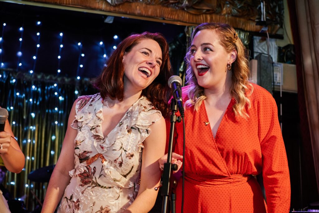 wedding guests singing on stage at The Ivy House